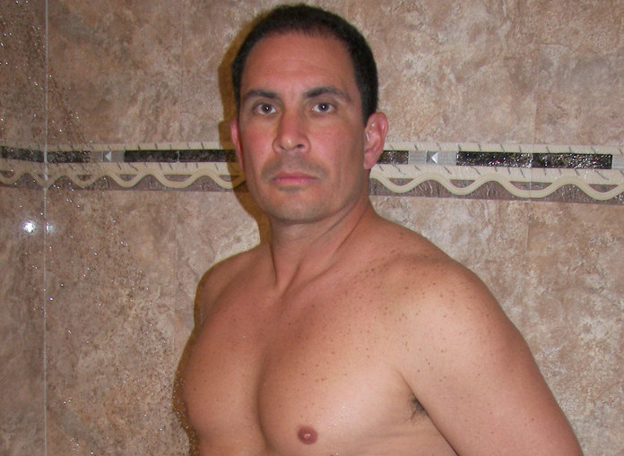 Beefy Latino posing in the shower