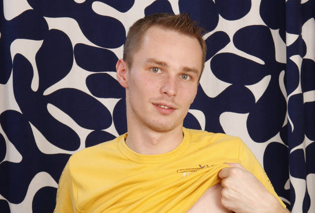 Cute male model lifts his shirt